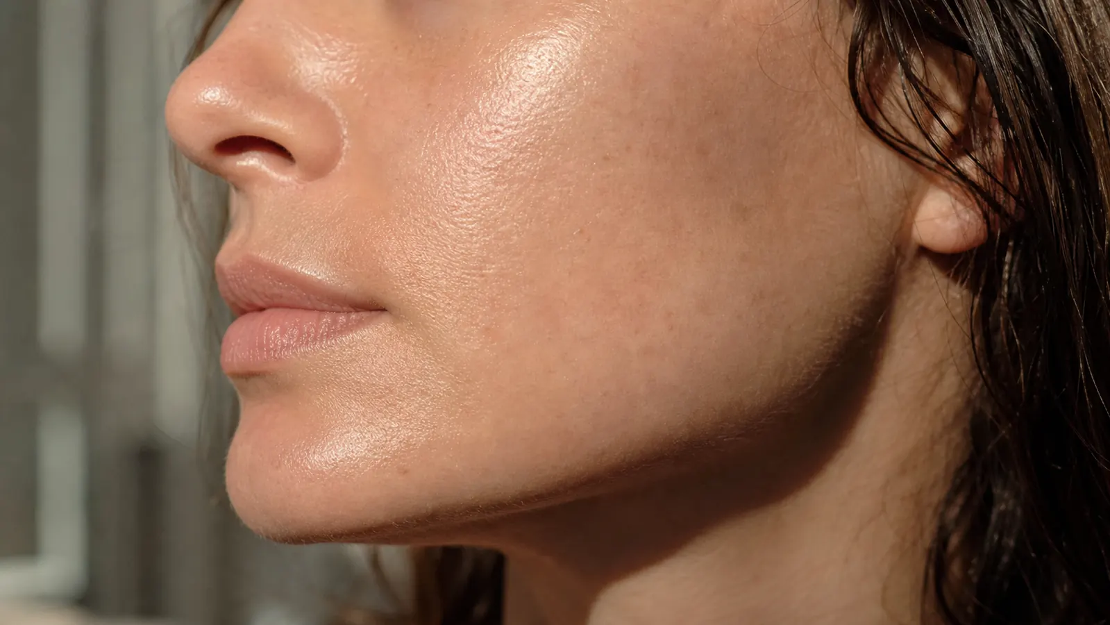 Close-up of glowing, plump skin in morning light after overnight masking session