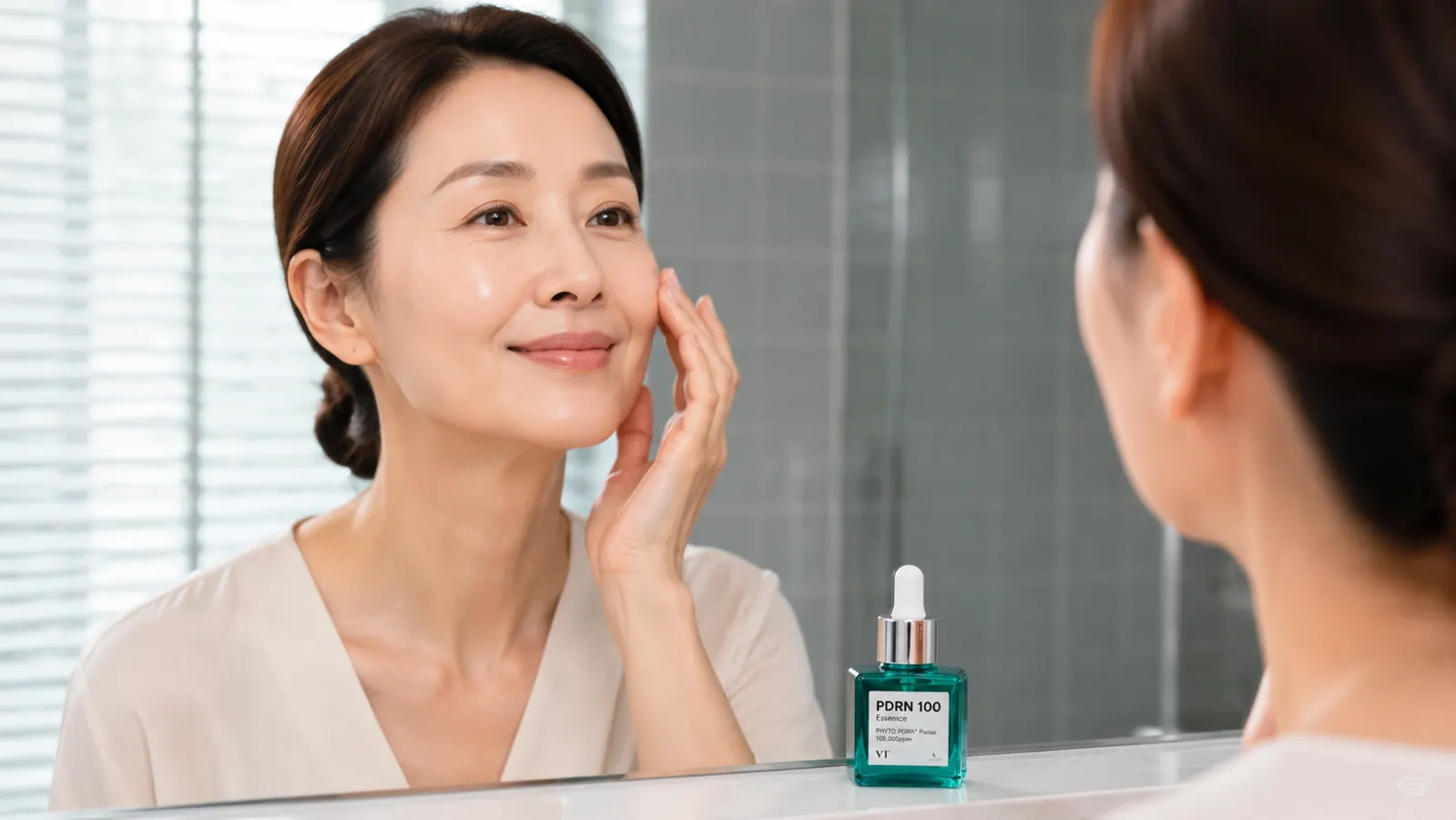 Woman pressing two drops of VT COSMETICS PDRN 100 Essence onto her palm before applying to her face